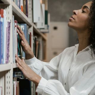 Person browsing a bookshelf