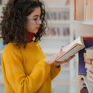 Person browsing books at the library